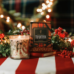 Jackson Vaughn Tradition Holiday Candle with red berries and gold and white lit candle