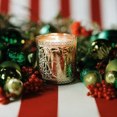 Jackson Vaughn Tradition Holiday Candle with red berries and gold and white lit candle
